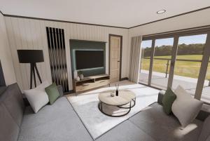 ein Wohnzimmer mit einem Sofa, einem Tisch und einem TV in der Unterkunft Tattershall Lakes Country Park in Tattershall