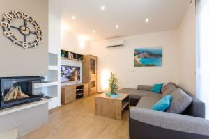 a living room with a couch and a tv at Villa Velum in Mravince