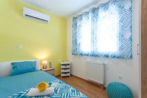 a bedroom with a blue bed and a window at Villa Velum in Mravince +22 photos