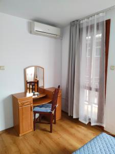 a bedroom with a desk and a mirror at Guest Rooms Melsambria in Nesebar