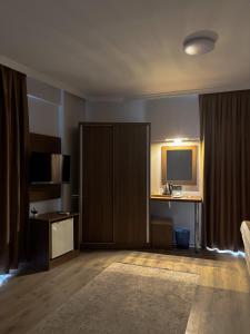 a hotel room with a television and a sliding door at Gulluk Life Hotel in Gulluk