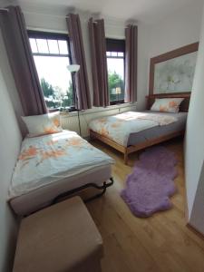 a bedroom with two beds and a purple rug at SUNNY SIDE in Kiel