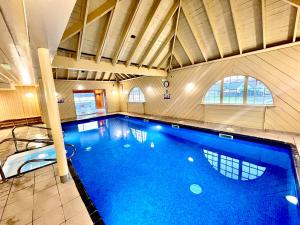 een groot zwembad in een grote kamer met bij Glenachulish Bay with Hot Tub in Glencoe