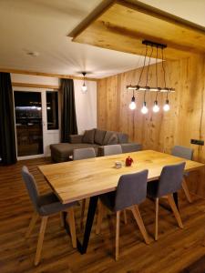 a dining room with a table and a couch at Haus Rätikon in Brand