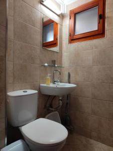 a bathroom with a toilet and a sink at Guest Rooms Melsambria in Nesebar