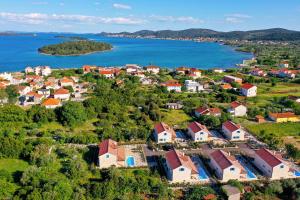 an aerial view of a small town next to a body of water at Papa's Court II Pasman Villa with pool in Pašman