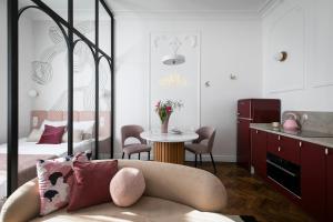 a bedroom with a bed and a couch and a table at Retro Apartamenty in Przemyśl