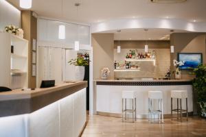 a kitchen with a bar with stools in it at Hotel Lalla Beauty & Relax in Cesenatico