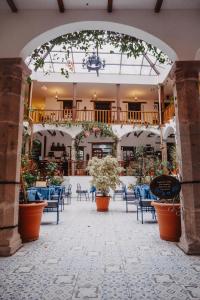 an archway with chairs and tables in a building at Hotel Casa Alquimia in Quito