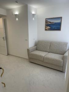 a living room with a couch and a painting on the wall at Amalfi Suite Boutique Hotel in Amalfi