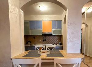 a kitchen with a table and chairs in a room at Beach Bliss Apartment in Pržno