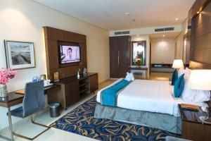 Postel nebo postele na pokoji v ubytování Omega Hotel Dubai