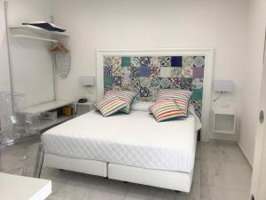 a white bed with two pillows in a bedroom at Amalfi Suite Boutique Hotel in Amalfi