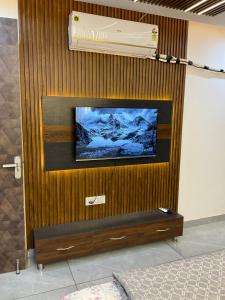 a wall with a tv on a wooden wall at Guru Ji Homes in Dehradun
