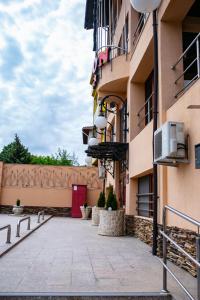 a courtyard of a building with a red door at Hotel Rion in Mangalia