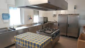 a kitchen with a stove and a sink at Villa Serena in Lignano Sabbiadoro