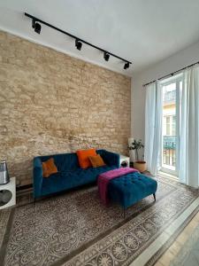 - un salon avec un canapé bleu et un mur en briques dans l'établissement Alicante Beach Home, à Alicante