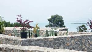 a stone retaining wall with two chairs and a table at RUSTICO in Široka