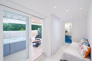 a living room with a window and a tub at Amalfi Suite Boutique Hotel in Amalfi