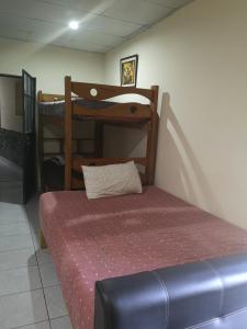 a bedroom with a bed and bunk beds in a room at la casa de los amigos in Arequipa