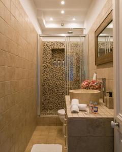 a bathroom with a shower and a toilet and a sink at Villa Fantaisie in Menton +32 photos