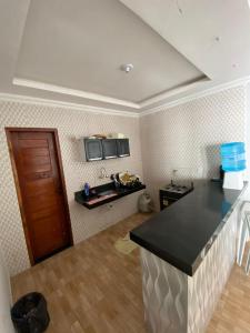 a kitchen with a counter top in a room at Nosso Sítio in Camocim