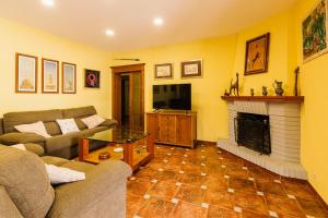 a living room with a couch and a fireplace at Precioso Chalet Atlántida solo familias in Roche