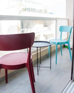 a table and chairs sitting next to a window at Stylish 2 Bed 2 Bath Apt in St Julians in St. Julianʼs