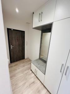 an empty room with a mirror and a door at Apartmán v centre mesta in Dubnica nad Váhom