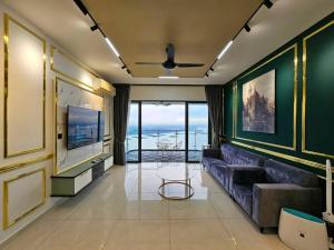 a living room with a couch and a view of the ocean at Royal Strand, Country Garden Danga Bay, Johor Bahru, Johor in Johor Bahru