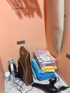 a room with a pile of clothes on a table at Montalban RestHouse 1 AC BR TownHouse in Rodriguez
