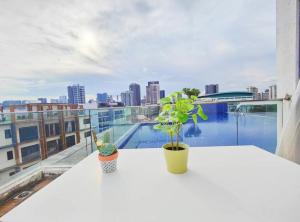 une table blanche avec une plante au-dessus d'un bâtiment dans l'établissement Centralize Stylish Loft Apartment Beside Mrt 摩登小屋, à Singapour