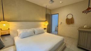 Postel nebo postele na pokoji v ubytování Hotel Noah Tulum