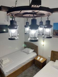 a room with a bed and a group of lights at MUNIS Hotel lyabi houz in Bukhara