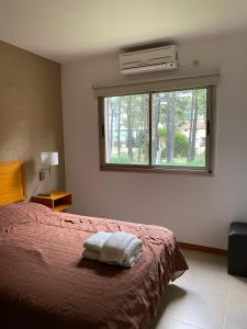 a bedroom with a bed and a window at Complejo Totoras in Pinamar +47 photos