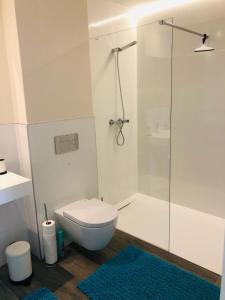 a bathroom with a toilet and a glass shower at Luxury Apartment Diego - The View Fuengirola in Fuengirola