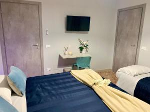 a bedroom with two beds and a table with a desk at Affittacamere LA FRANCIGENA in Fucecchio