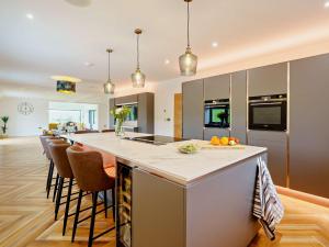 a kitchen with a large island with bar stools at 4 Bed in Shap 89957 in Shap