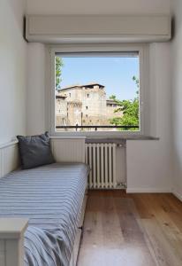 a bedroom with a bed and a large window at La Sismonda in Rimini