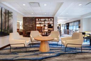 a lobby with chairs and a table and a table andchairs at Fairfield Inn and Suites by Marriott Rochester West/Greece in Rochester