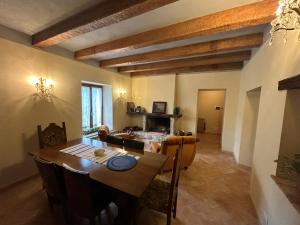 a dining room and living room with a table and chairs at Appartamento Storico a Valle San Martino di Spoleto in Spoleto