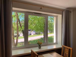 two windows in a dining room with a table and a table at DIKOL Two-Room Apartment-SELF CHECK-in & FREE Parking Near City Center in Tallinn
