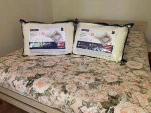 two pillows sitting on top of a bed at DIKOL Two-Room Apartment-SELF CHECK-in & FREE Parking Near City Center in Tallinn