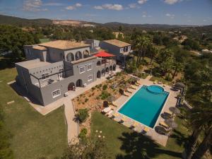 an aerial view of a house with a swimming pool at Canaan Boutique Casa do Monte by Get Your Stay in Boliqueime
