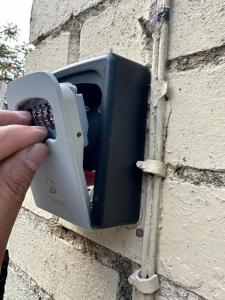 a person holding a remote control in a wall outlet at Reat Bungalow of 207A in London