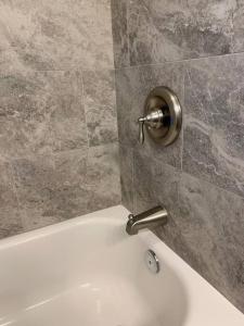 a bathroom with a bath tub and a sink at A beautiful sunset cottage in Hendersonville +12 photos