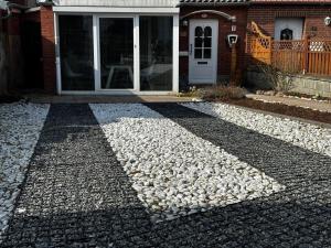 a house with a bunch of rocks on the driveway at Fehmarnliebe in Fehmarn