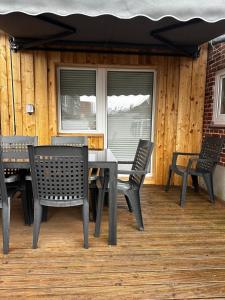 a table and chairs sitting on a deck at Fehmarnliebe in Fehmarn +15 photos