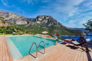 a swimming pool with a mountain in the background at Flavia Hotel in Kızılcakaya