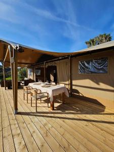 a tent with tables and chairs on a wooden deck at Casa Boavista in São Martinho do Porto